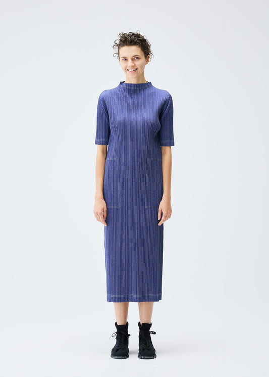 A model wears the PLEATS PLEASE ISSEY MIYAKE COTTON DENIM dress.
