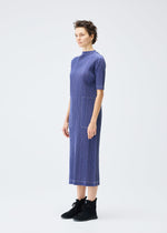 A model wears the PLEATS PLEASE ISSEY MIYAKE COTTON DENIM dress.