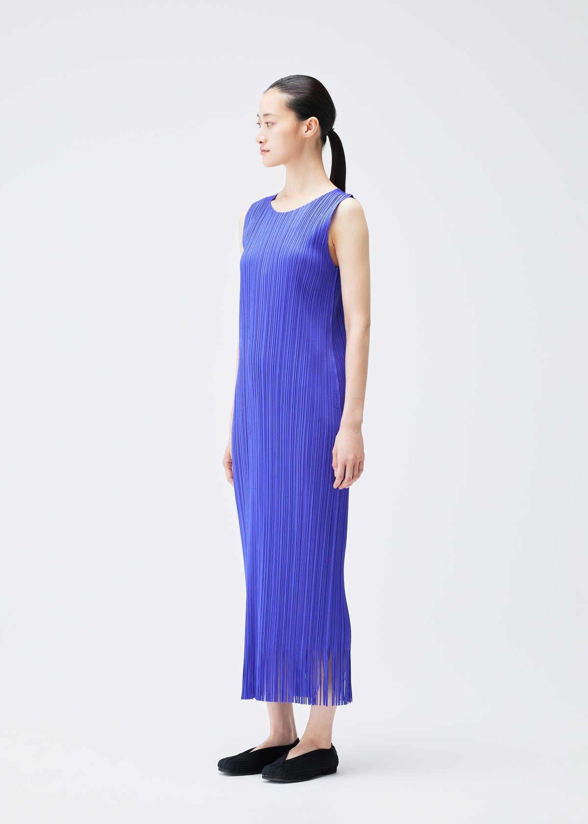 A model wears the PLEATS PLEASE ISSEY MIYAKE WAVE dress.
