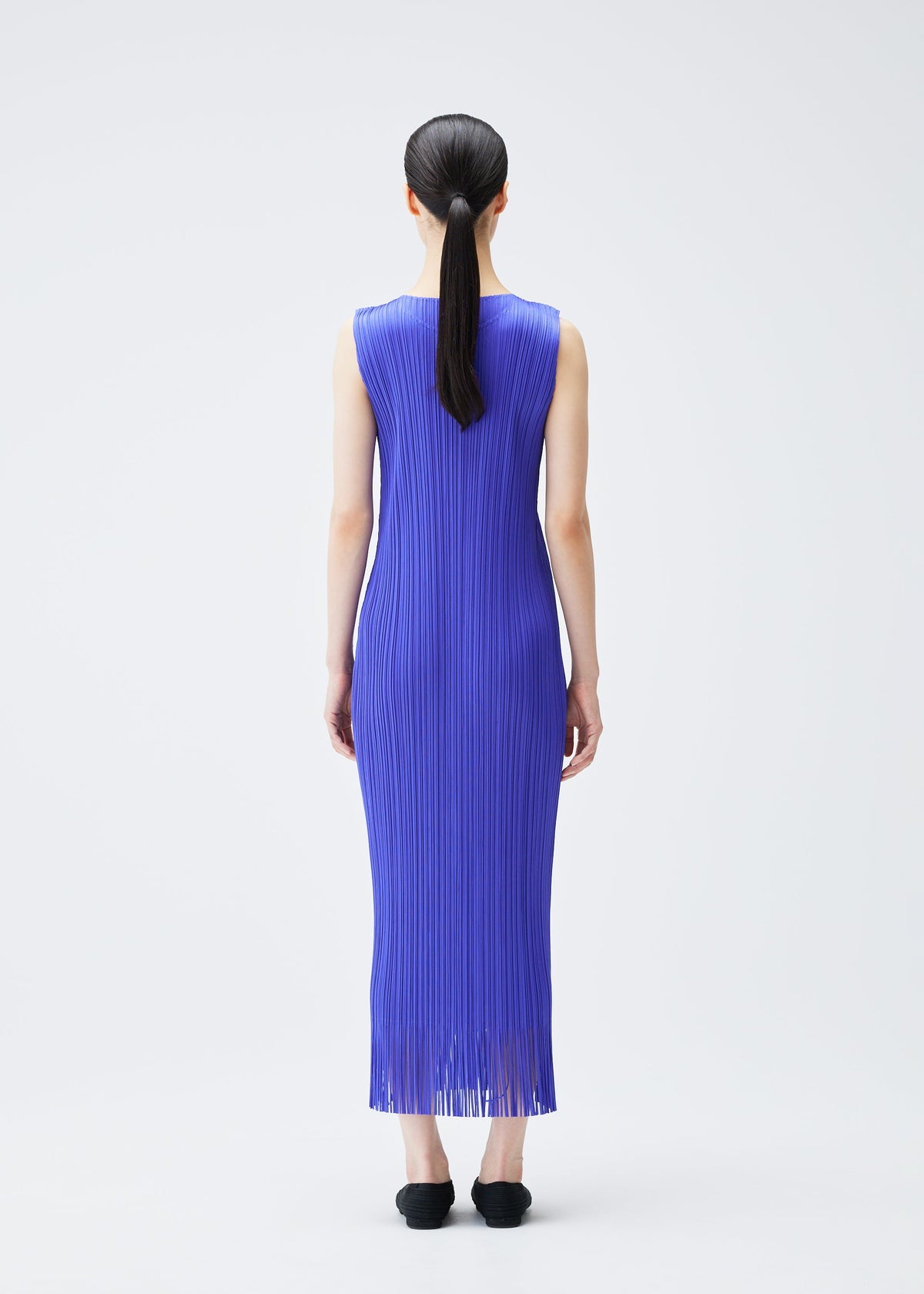A model wears the PLEATS PLEASE ISSEY MIYAKE WAVE dress.