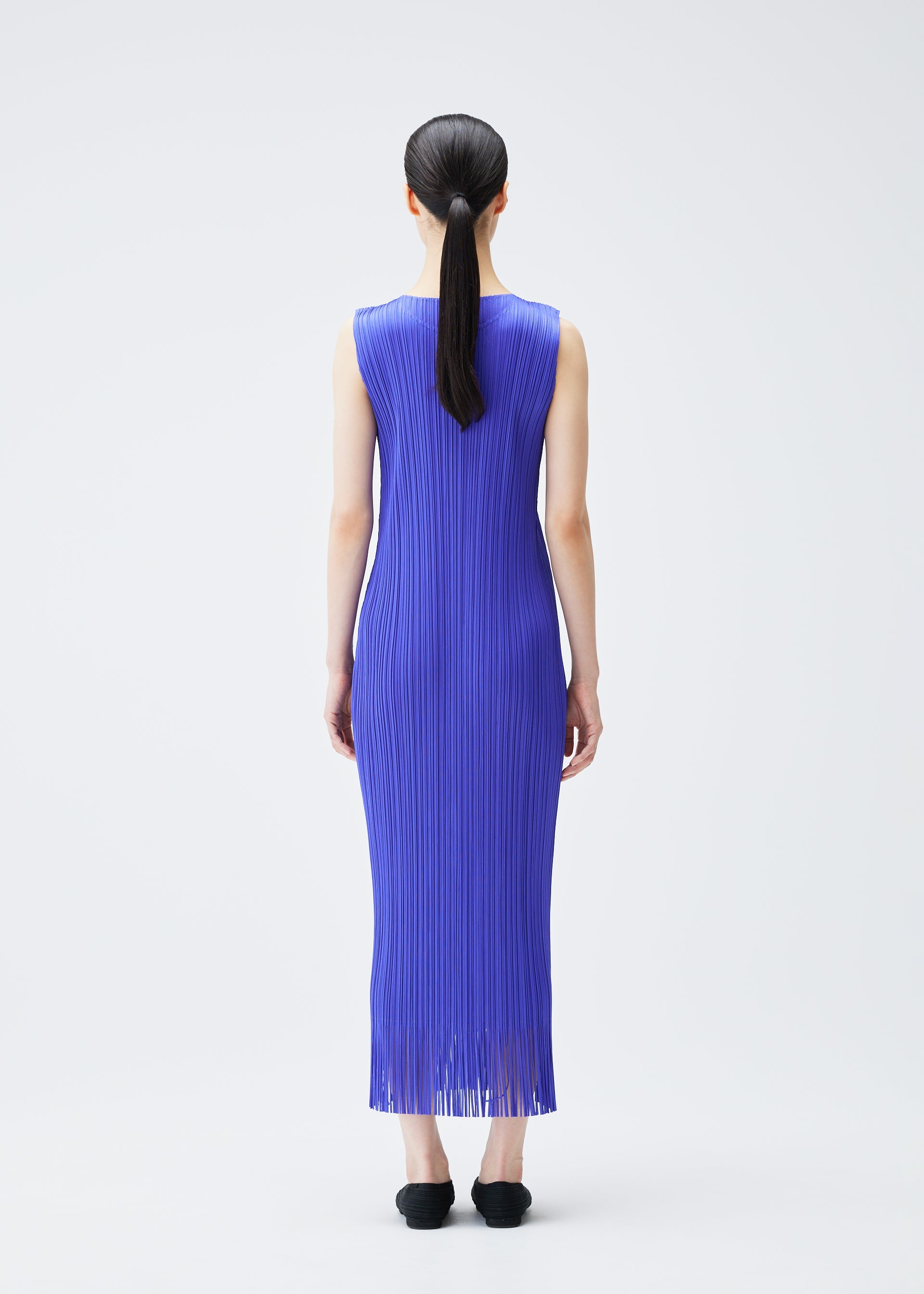 A model wears the PLEATS PLEASE ISSEY MIYAKE WAVE dress.