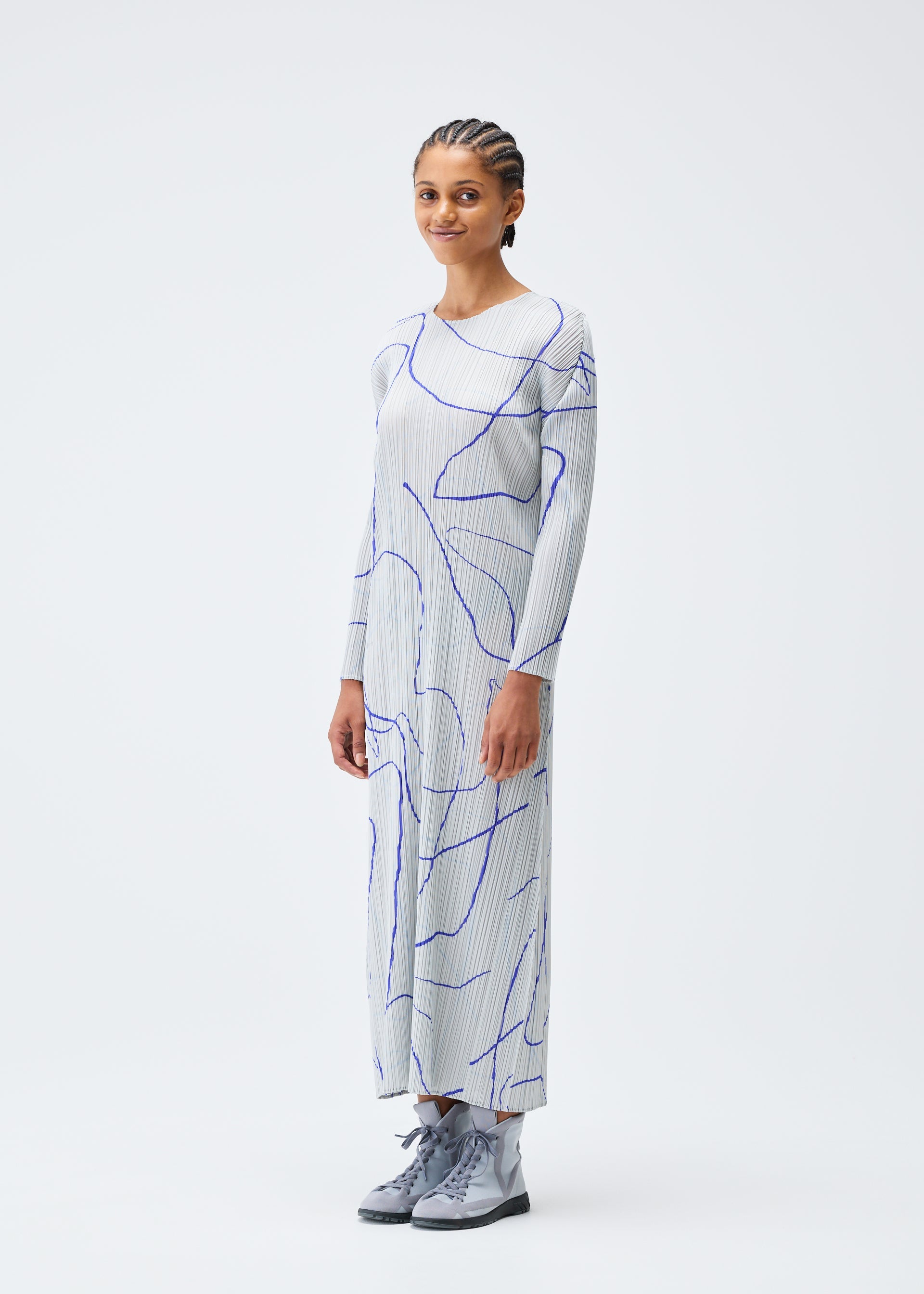 A model wears the Pleats Please Issey Miyake PAUSE dress.