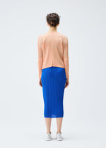 A model wears the PLEATS PLEASE ISSEY MIYAKE MONTHLY COLORS AUGUST cardigan.