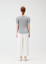 A model wears the Pleats Please Issey Miyake MIST APRIL shirt.