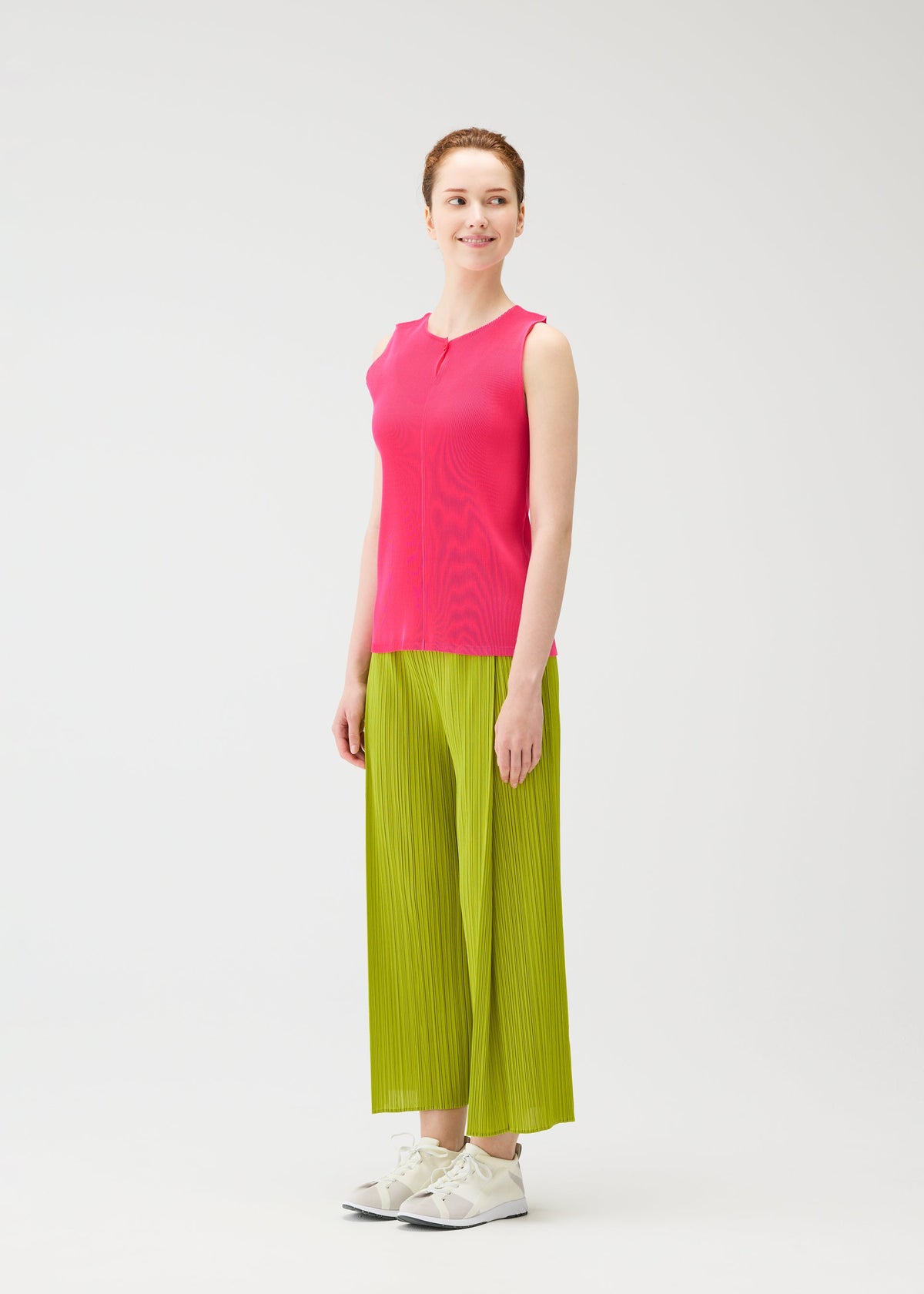 A model wears the PLEATS PLEASE ISSEY MIYAKE MIST JUNE mist-june-shirt-bright-pink.