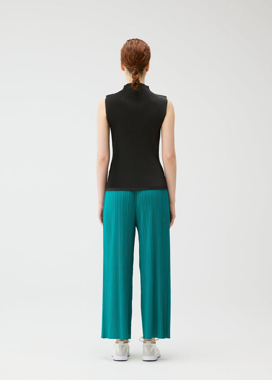 A model wears the PLEATS PLEASE ISSEY MIYAKE MIST JUNE mist-june-shirt-yellow-green-1.