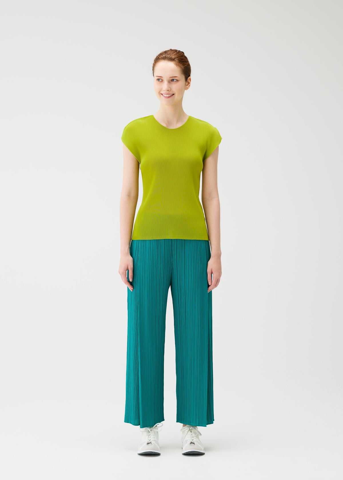 A model wears the PLEATS PLEASE ISSEY MIYAKE MIST JUNE mist-june-shirt-yellow-green-2.