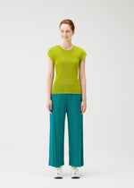 A model wears the PLEATS PLEASE ISSEY MIYAKE MIST JUNE mist-june-shirt-yellow-green-2.