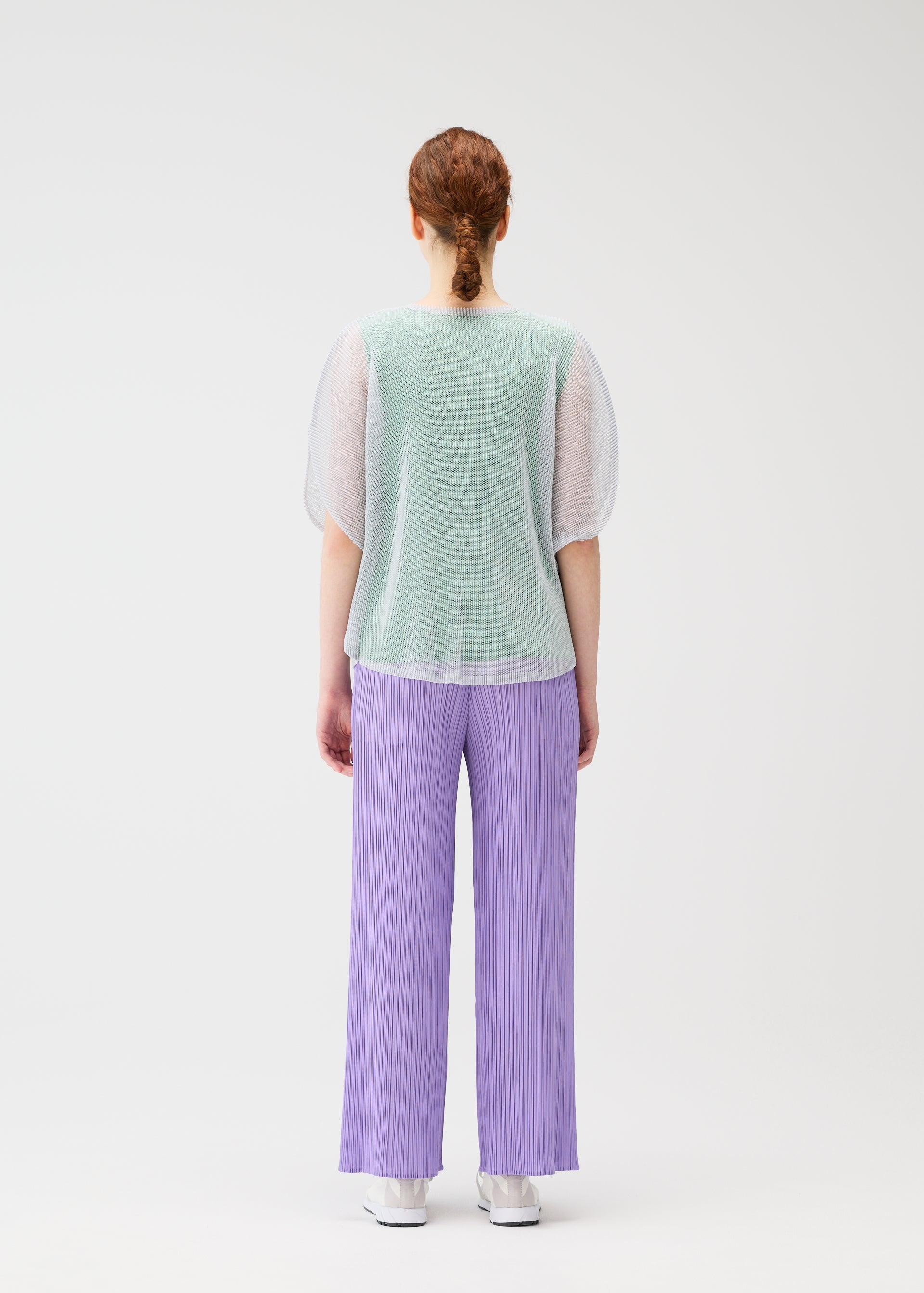 A model wears the Pleats Please Issey Miyake TATAMI APRIL shirt.