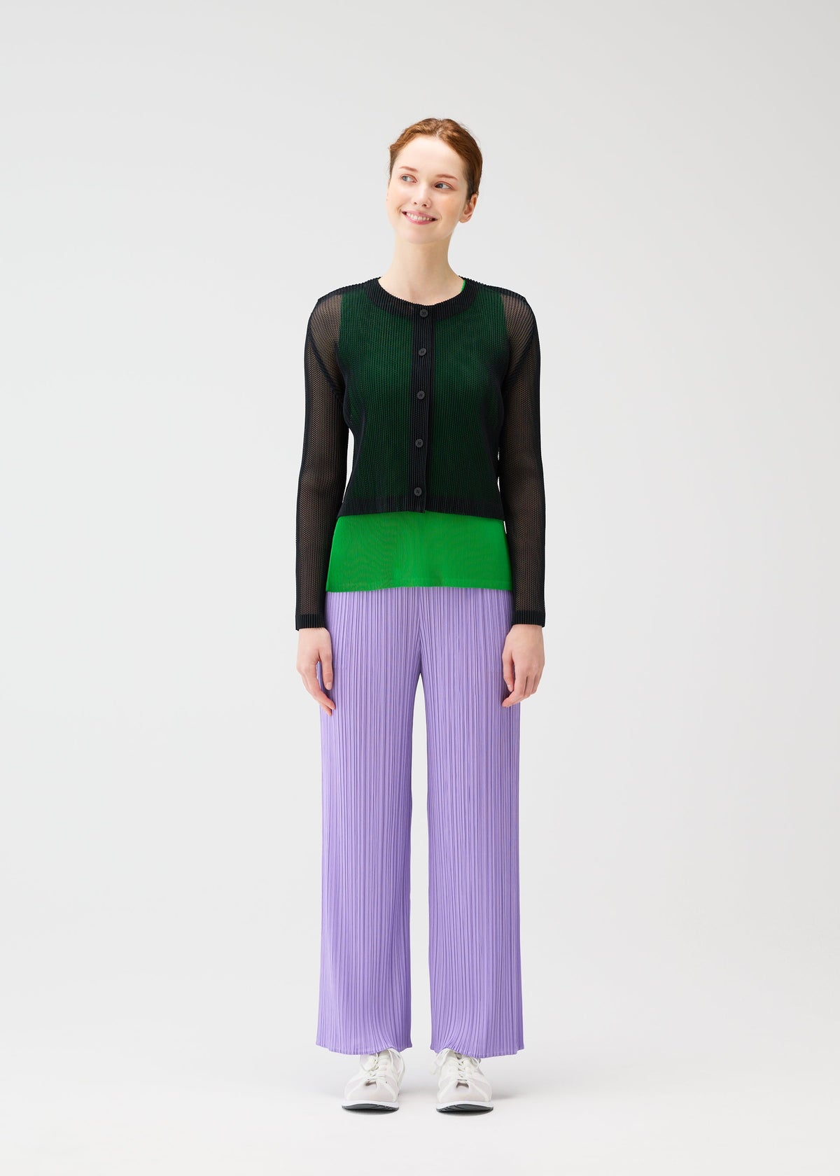 A model wears the Pleats Please Issey Miyake TATAMI APRIL cardigan.