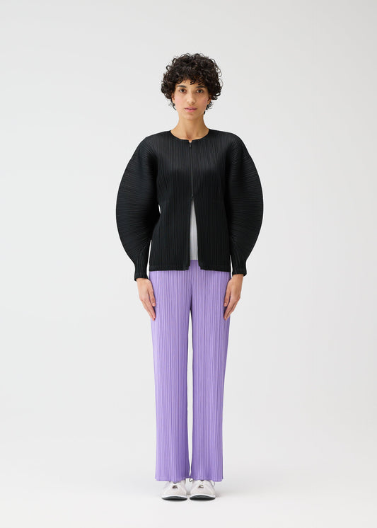 A model wears the Pleats Please Issey Miyake MONTHLY COLORS blouson.