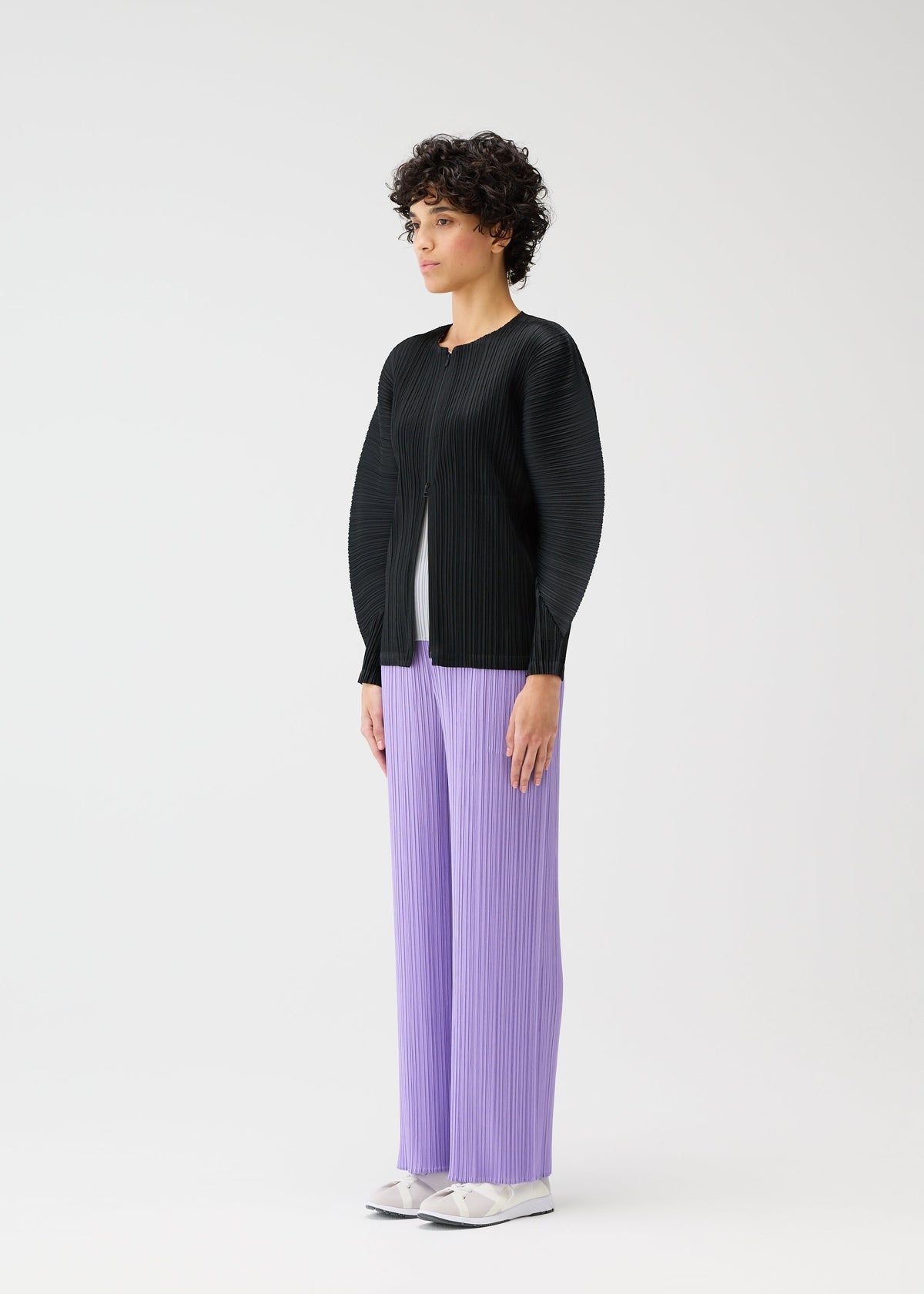 A model wears the Pleats Please Issey Miyake MONTHLY COLORS blouson.