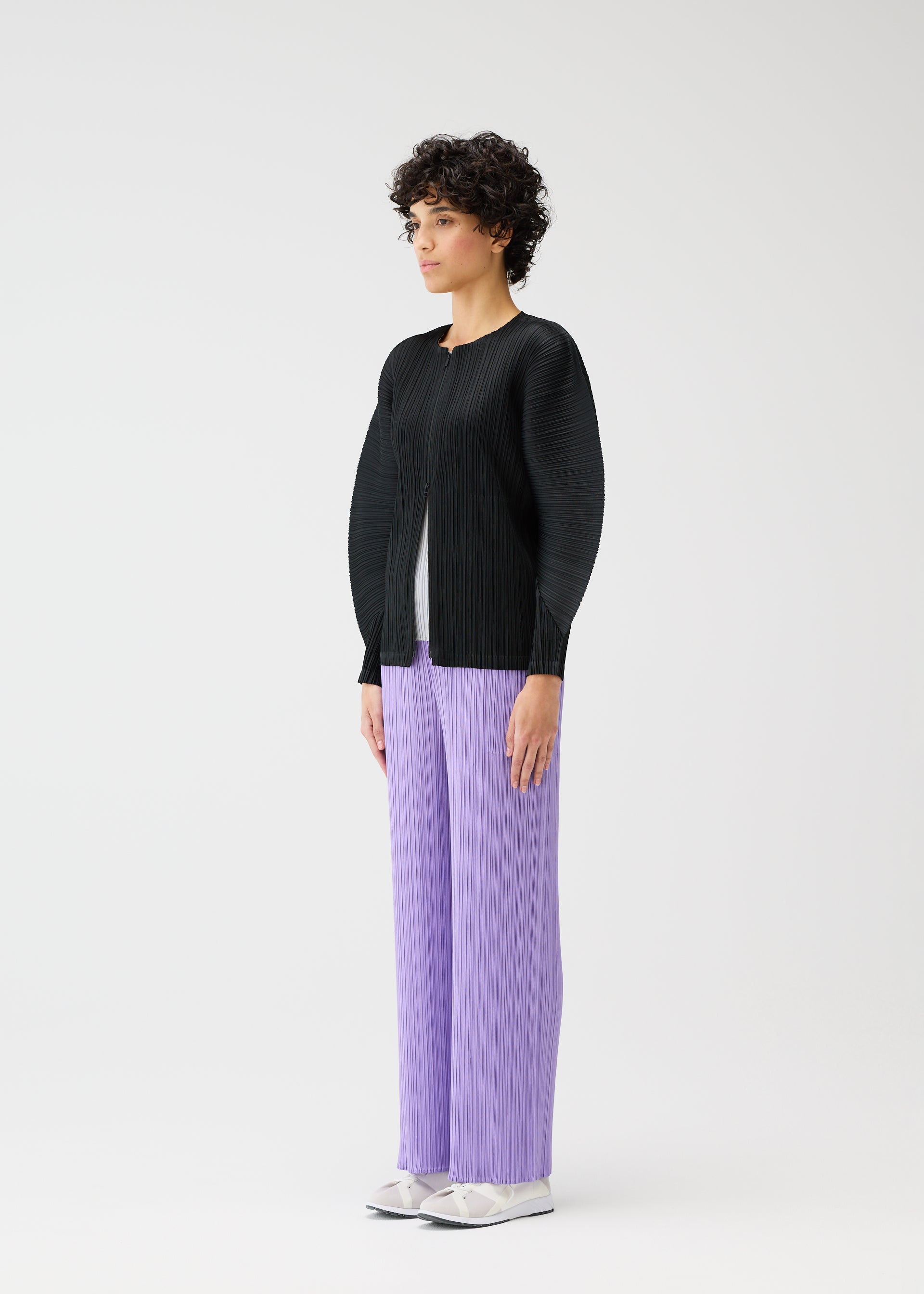 A model wears the Pleats Please Issey Miyake MONTHLY COLORS blouson.