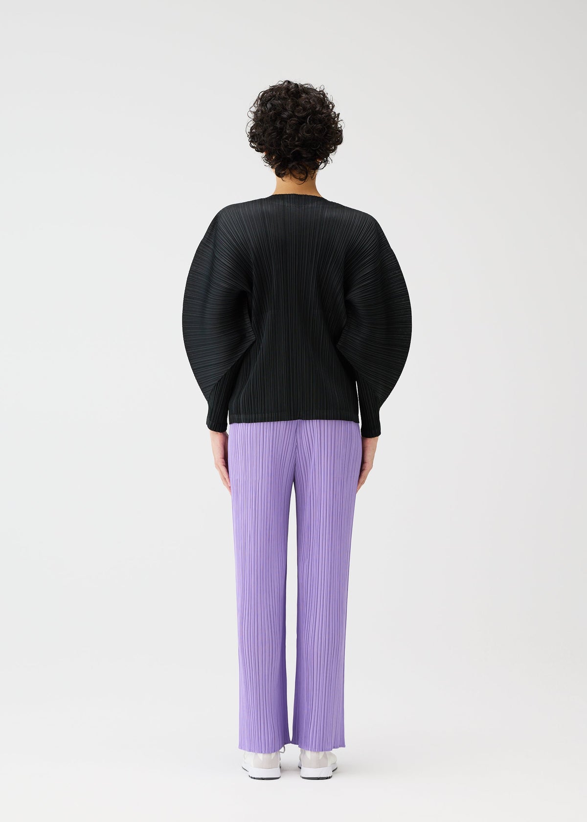 A model wears the Pleats Please Issey Miyake MONTHLY COLORS blouson.