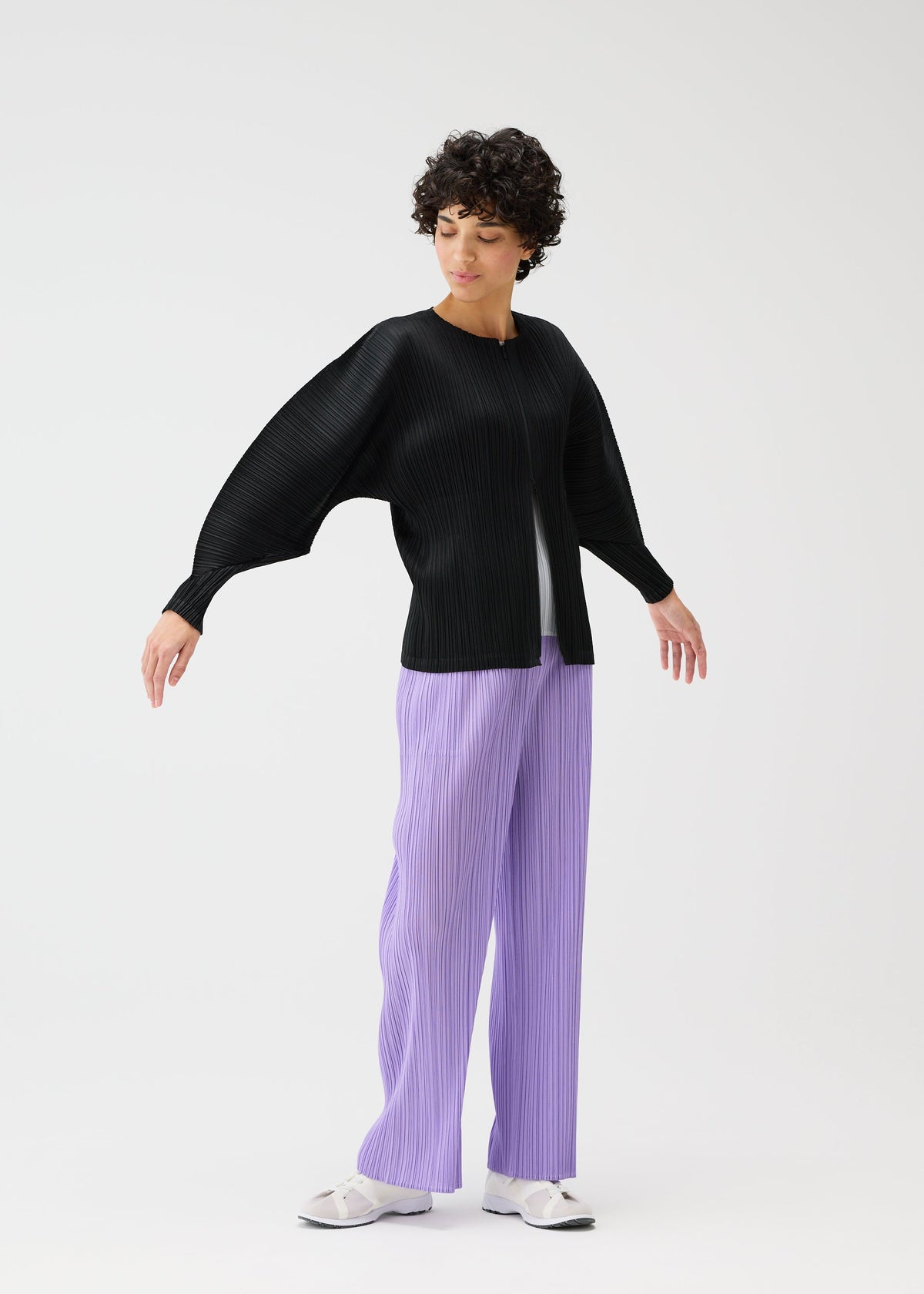 A model wears the Pleats Please Issey Miyake MONTHLY COLORS blouson.