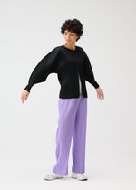 A model wears the Pleats Please Issey Miyake MONTHLY COLORS blouson.