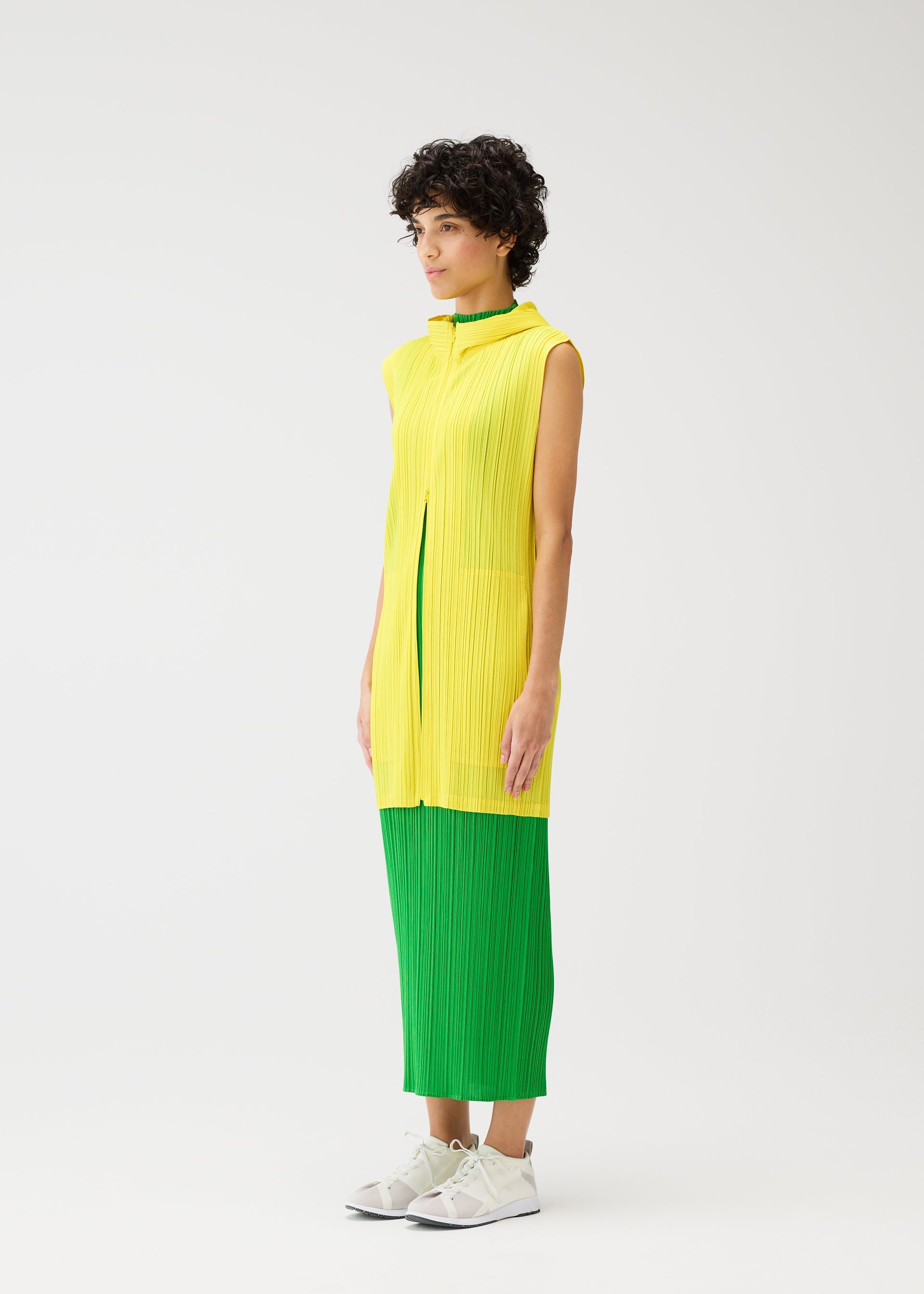 A model wears the Pleats Please Issey Miyake MONTHLY COLORS vest.