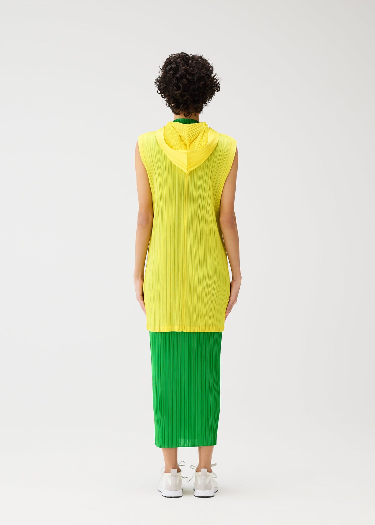 A model wears the Pleats Please Issey Miyake MONTHLY COLORS vest.