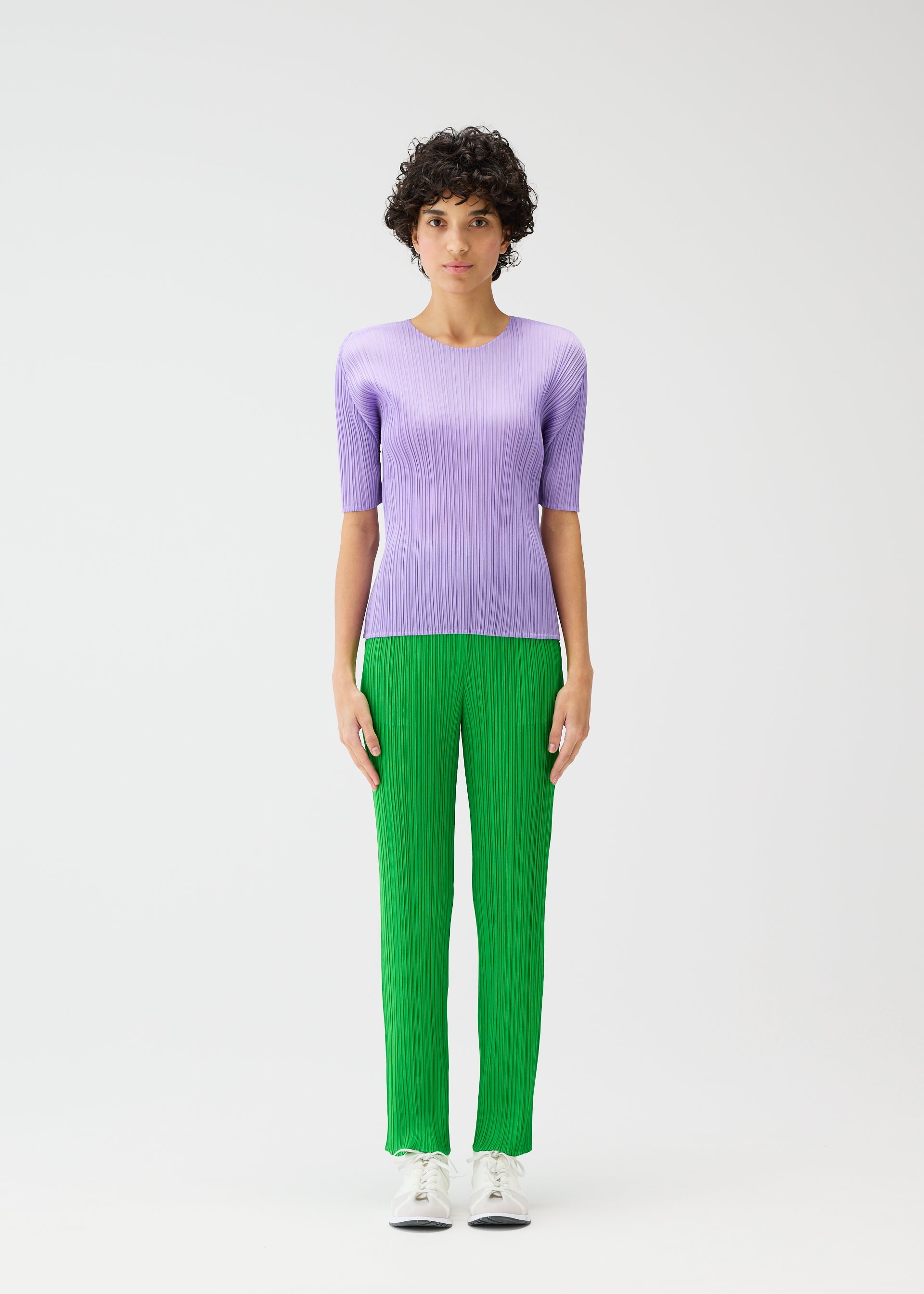 A model wears the Pleats Please Issey Miyake MONTHLY COLORS pants.