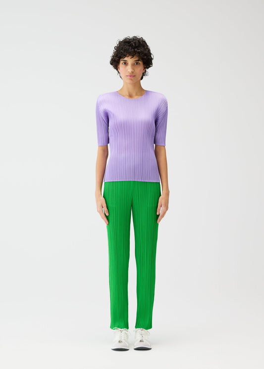 A model wears the Pleats Please Issey Miyake MONTHLY COLORS pants.