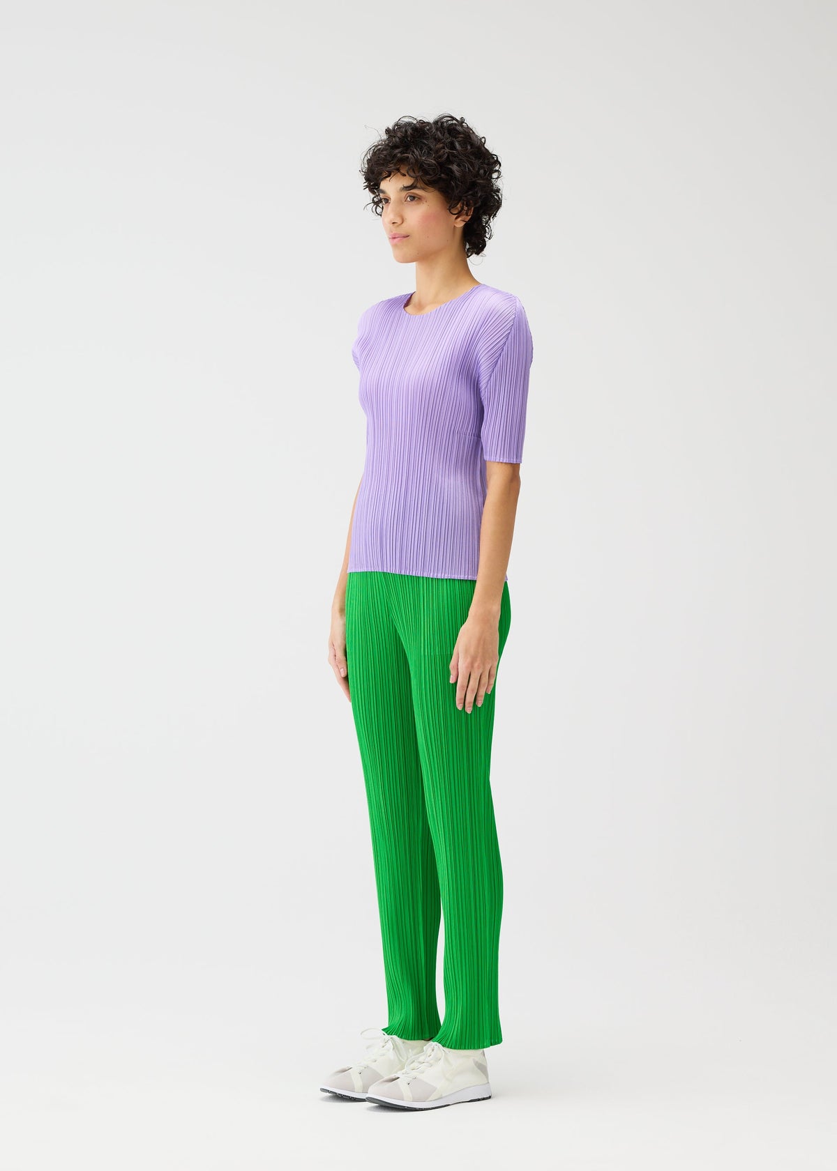 A model wears the Pleats Please Issey Miyake MONTHLY COLORS pants.