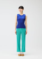 A model wears the Pleats Please Issey Miyake MONTHLY COLORS MAY trousers.
