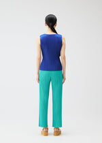A model wears the Pleats Please Issey Miyake MONTHLY COLORS MAY trousers.