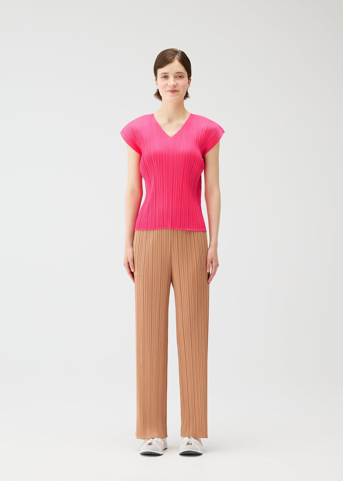 A model wears the PLEATS PLEASE ISSEY MIYAKE MONTHLY COLORS : JUNE monthly-colors-june-trousers-yellow-green.