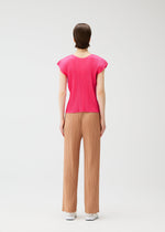 A model wears the PLEATS PLEASE ISSEY MIYAKE MONTHLY COLORS : JUNE monthly-colors-june-trousers-yellow-green.