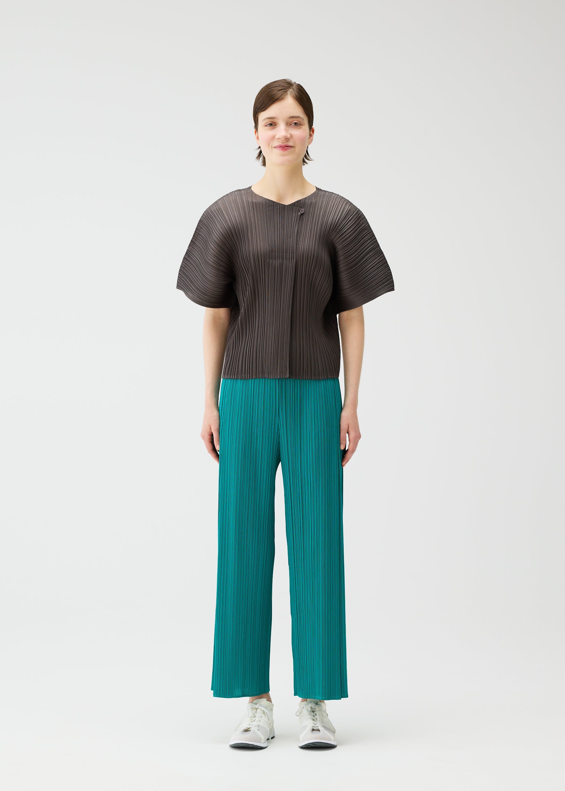 A model wears the PLEATS PLEASE ISSEY MIYAKE MONTHLY COLORS : JUNE monthly-colors-june-trousers-blue-green-3.