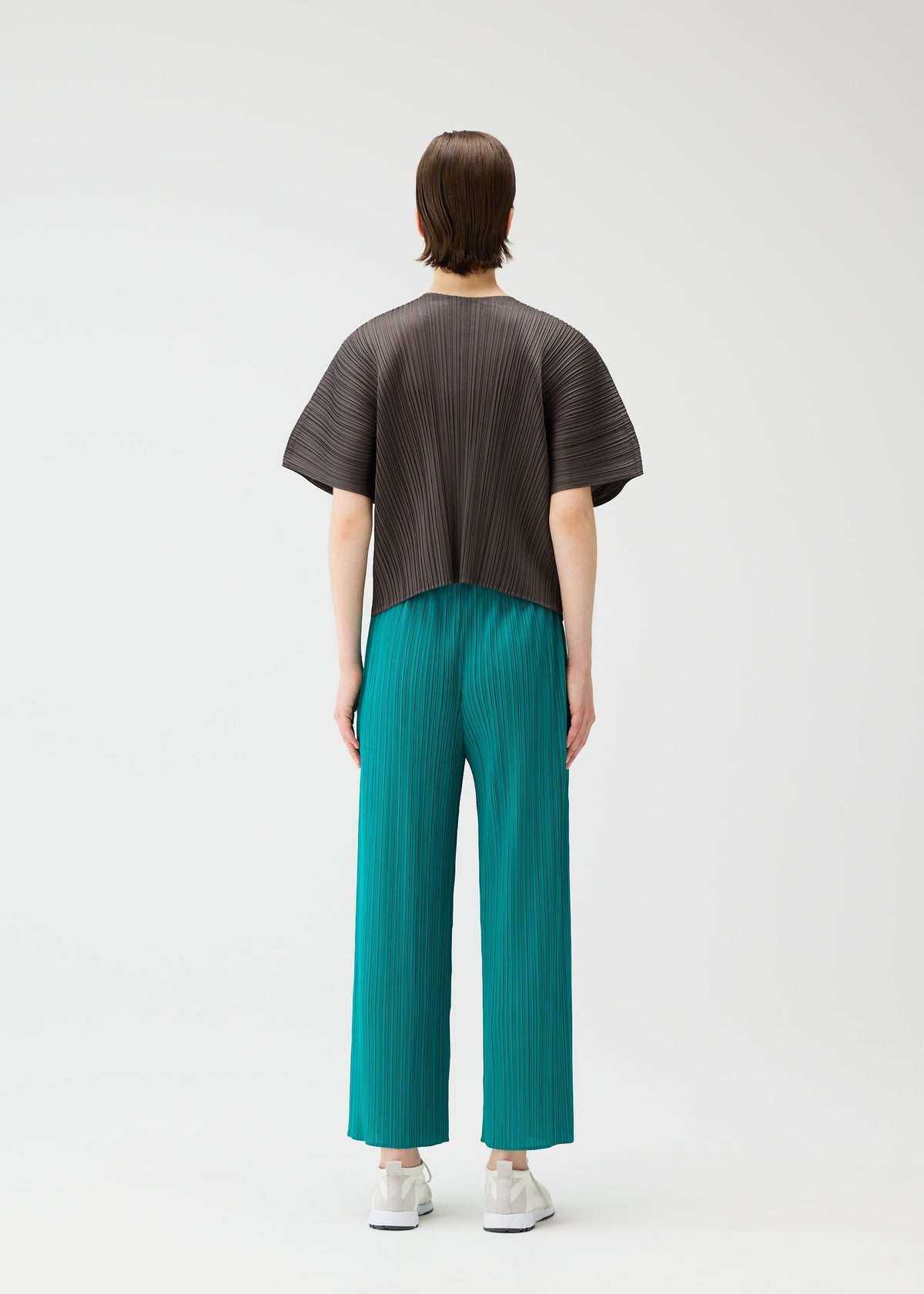 A model wears the PLEATS PLEASE ISSEY MIYAKE MONTHLY COLORS : JUNE monthly-colors-june-trousers-blue-green-3.