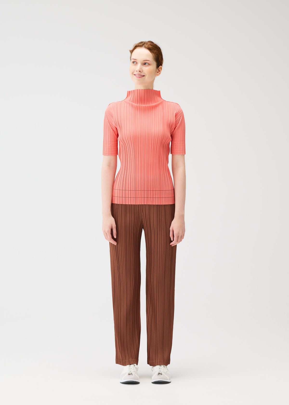 A model wears the Pleats Please Issey Miyake THICKER BOTTOMS 2 prêt à porter.