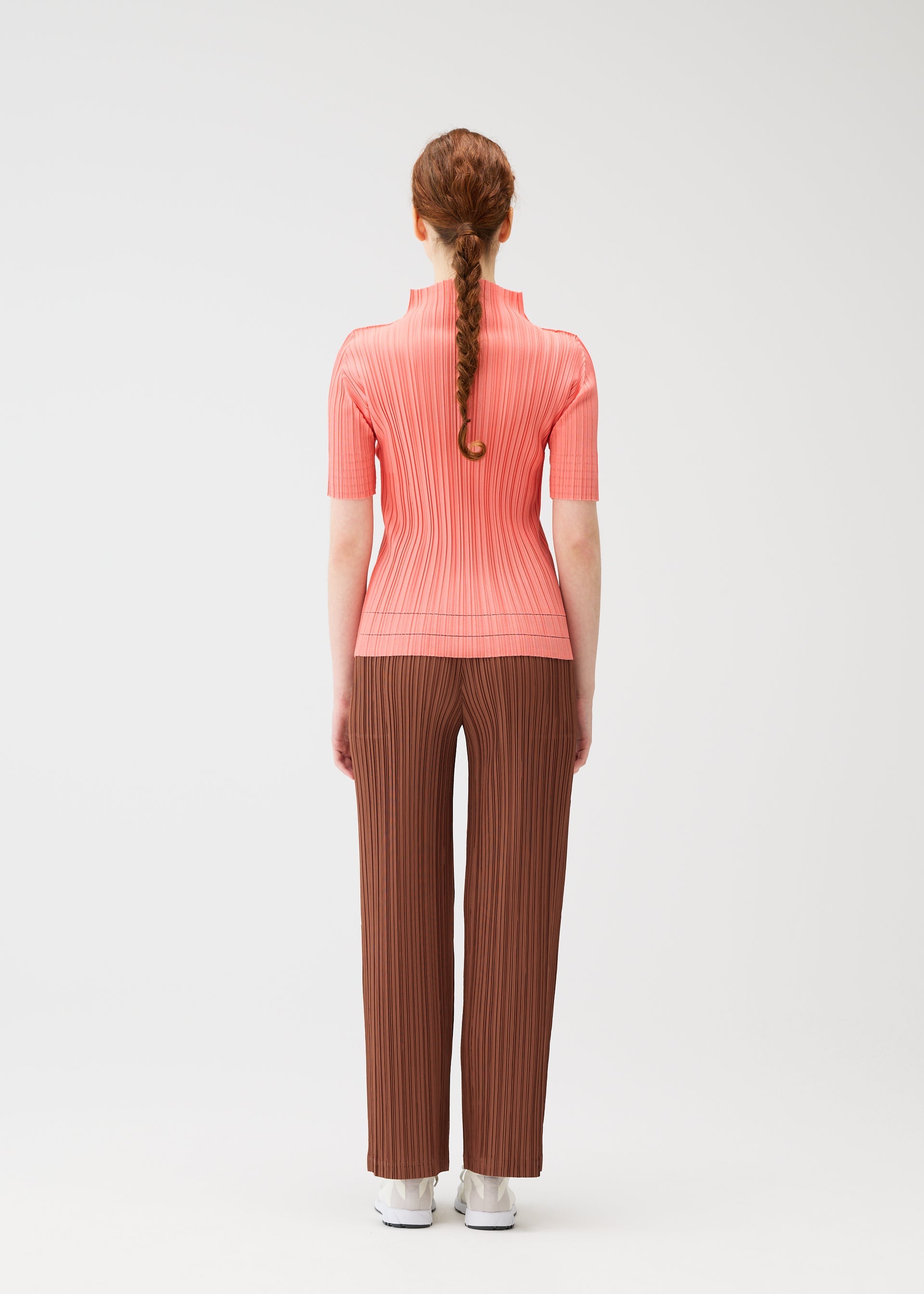 A model wears the Pleats Please Issey Miyake THICKER BOTTOMS 2 prêt à porter.