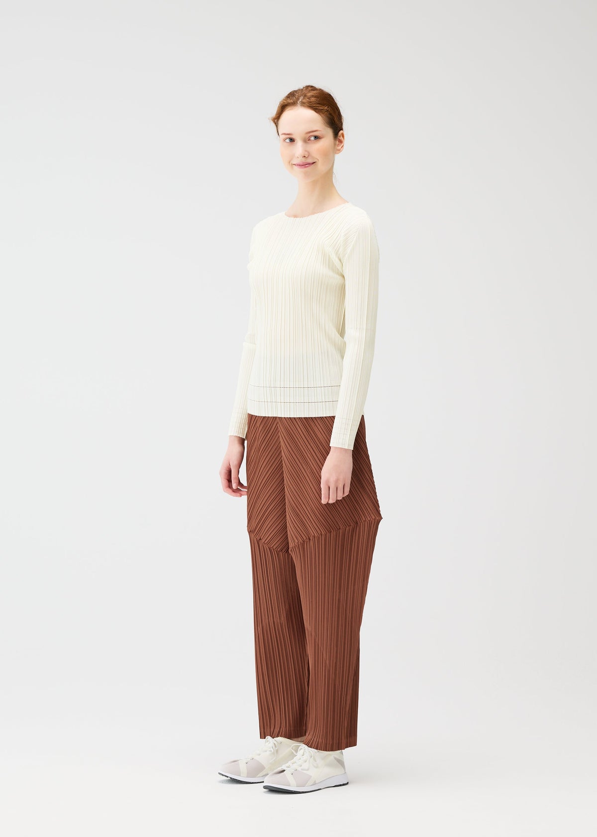A model wears the Pleats Please Issey Miyake THICKER BOTTOMS 2 prêt à porter.