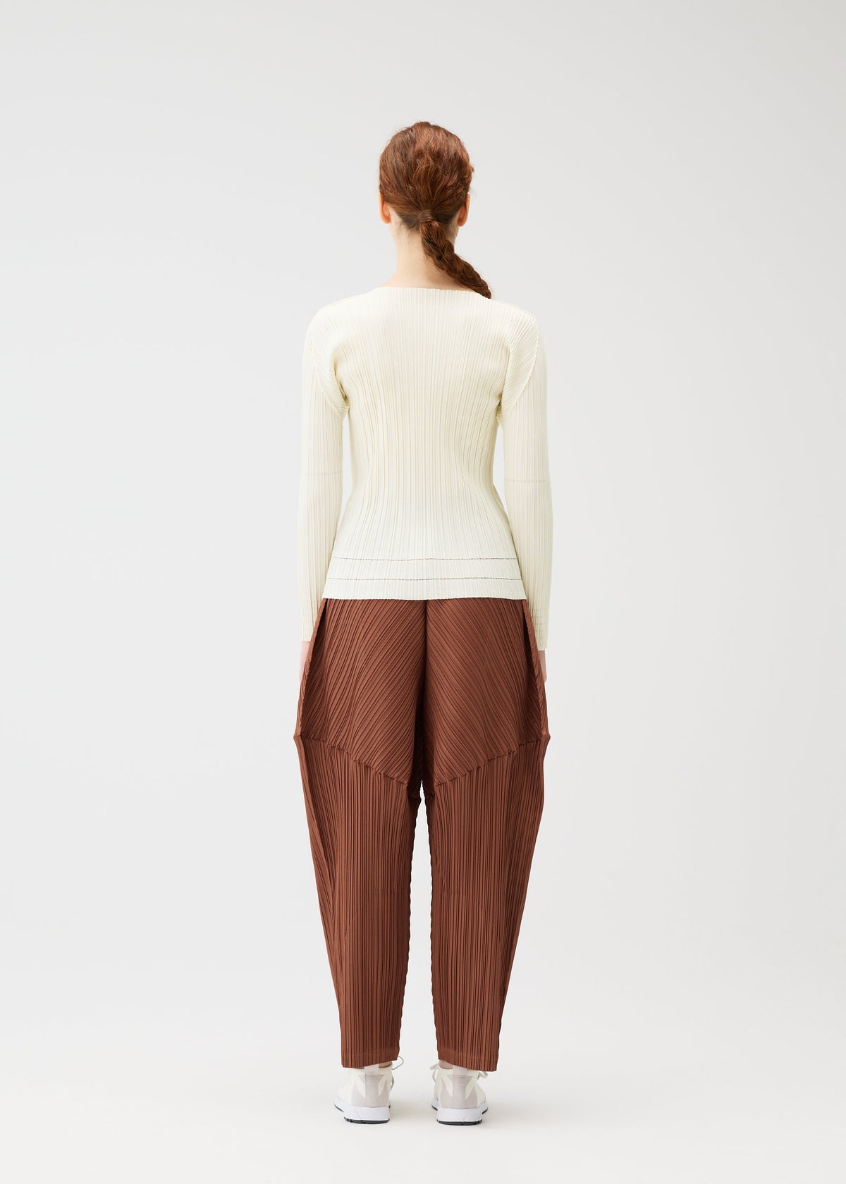 A model wears the Pleats Please Issey Miyake THICKER BOTTOMS 2 prêt à porter.