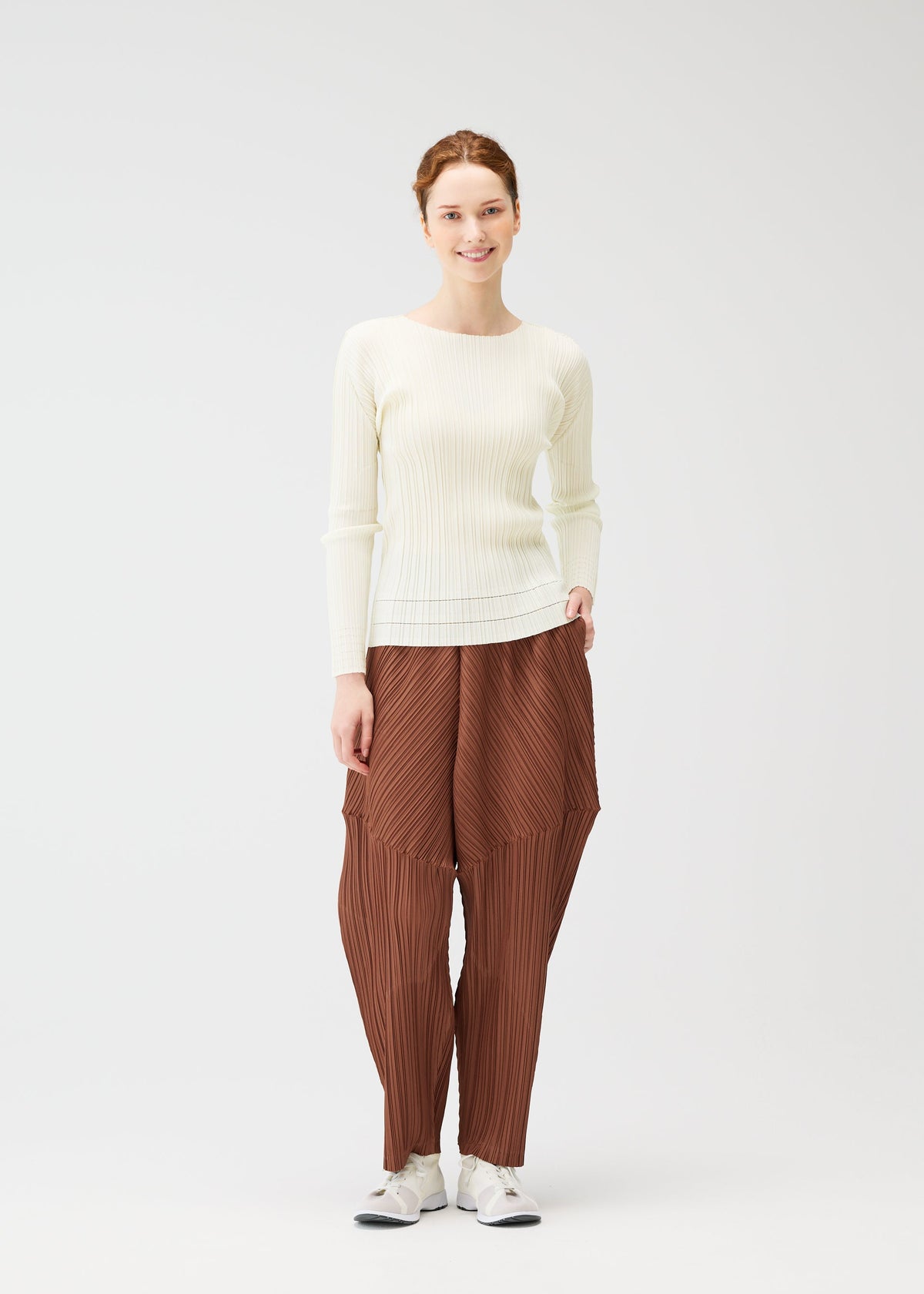 A model wears the Pleats Please Issey Miyake THICKER BOTTOMS 2 prêt à porter.