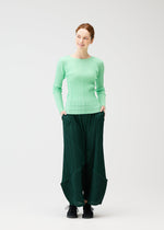 A model wears the Pleats Please Issey Miyake THICKER BOTTOMS 2 prêt à porter.