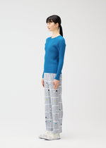 A model wears the PLEATS PLEASE ISSEY MIYAKE CROSSING DOTS prêt à porter.