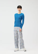 A model wears the PLEATS PLEASE ISSEY MIYAKE CROSSING DOTS prêt à porter.