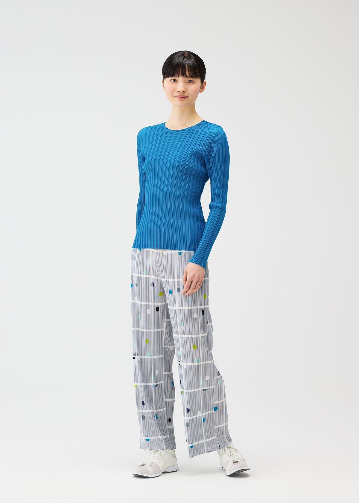 A model wears the PLEATS PLEASE ISSEY MIYAKE CROSSING DOTS prêt à porter.