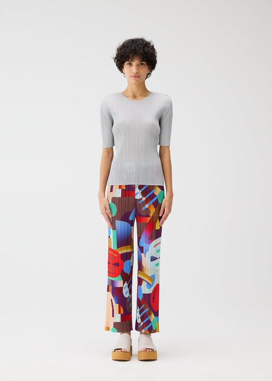 A model wears the Pleats Please Issey Miyake SODA POPS pants.