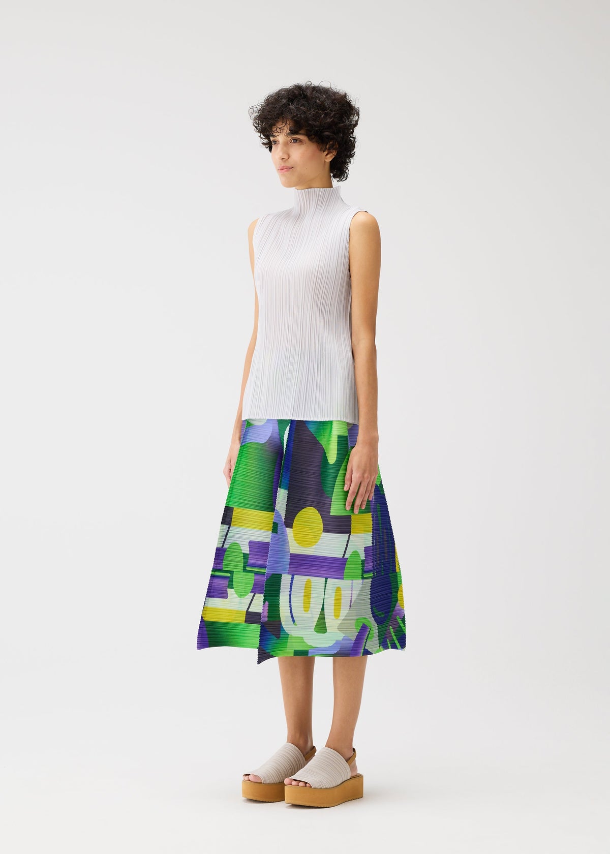 A model wears the Pleats Please Issey Miyake SODA POPS pants.