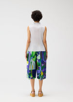 A model wears the Pleats Please Issey Miyake SODA POPS pants.