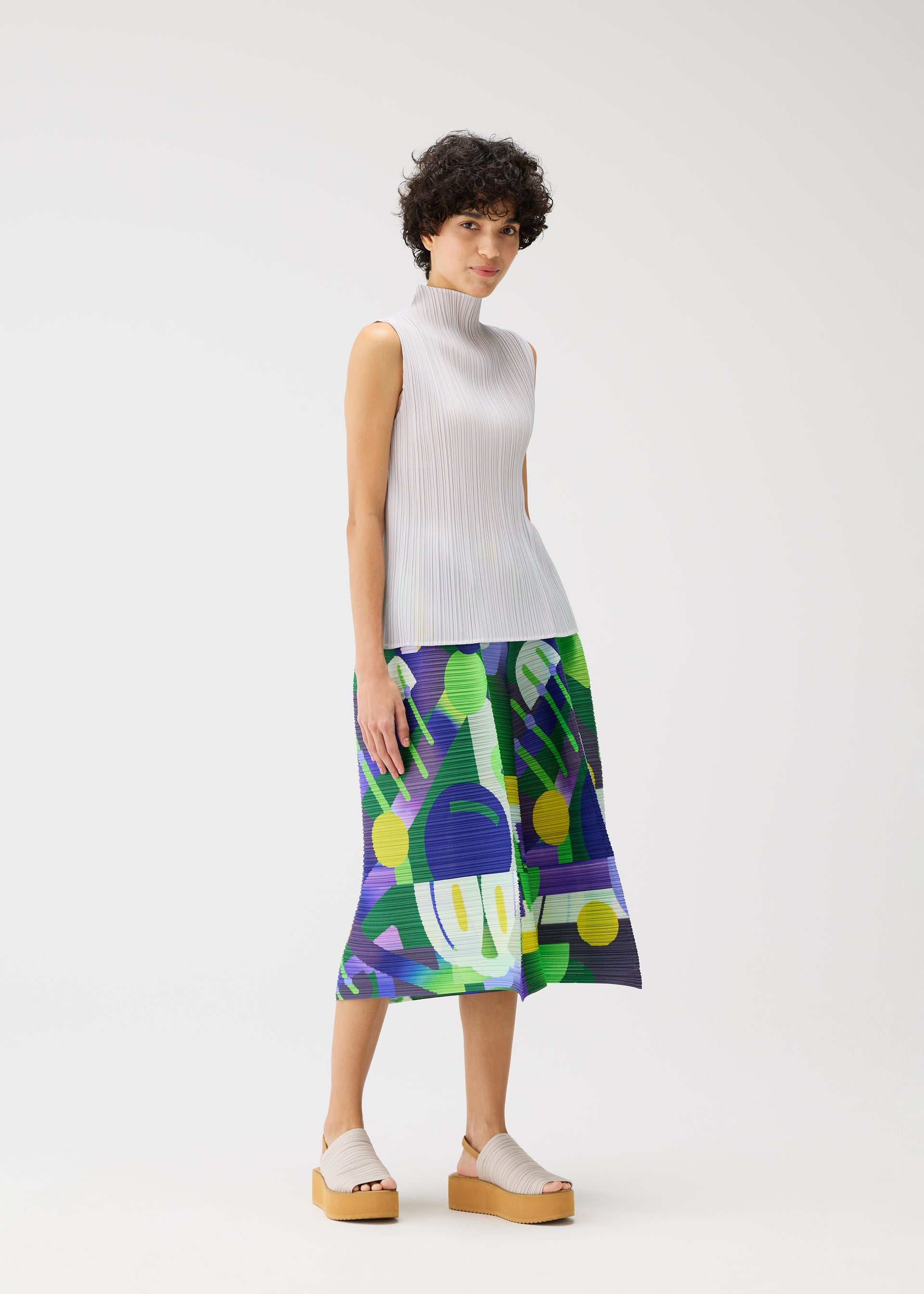 A model wears the Pleats Please Issey Miyake SODA POPS pants.