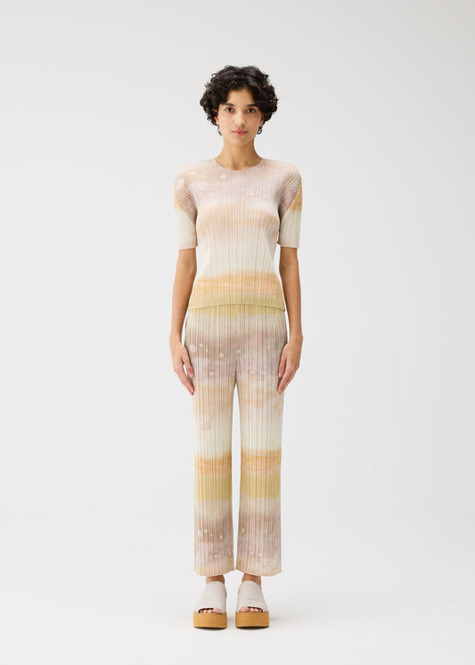 A model wears the Pleats Please Issey Miyake SEA BUBBLE trousers.