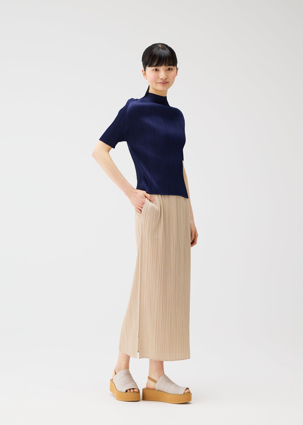 A model wears the Pleats Please Issey Miyake MONTHLY COLORS MAY skirt.
