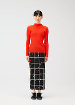 A model wears the PLEATS PLEASE ISSEY MIYAKE CROSSING DOTS prêt à porter.