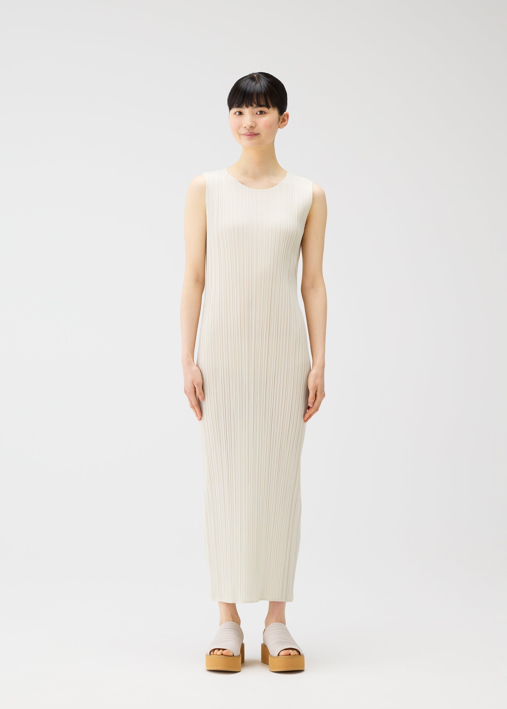 A model wears the Pleats Please Issey Miyake MONTHLY COLORS MAY dress.