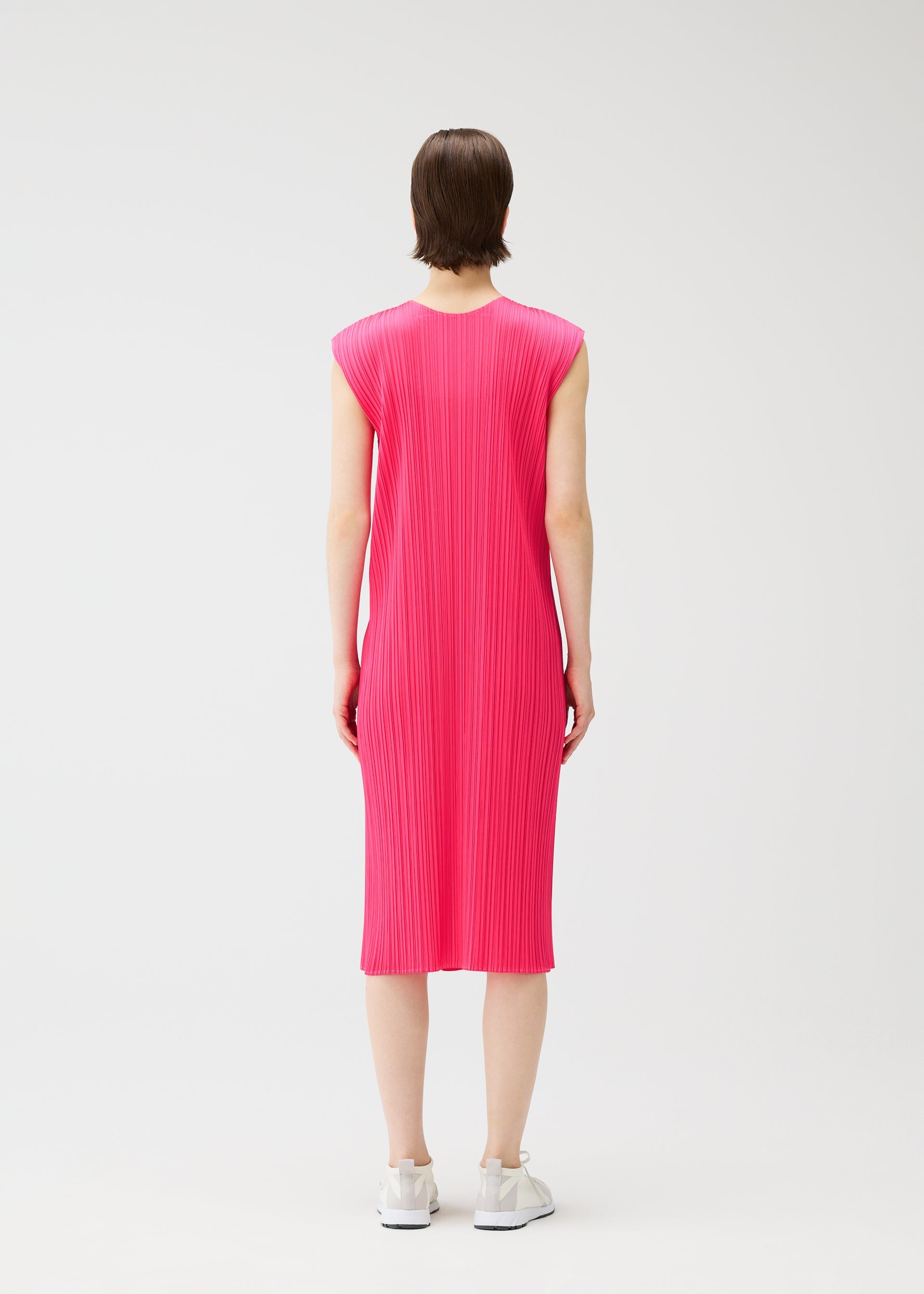 A model wears the PLEATS PLEASE ISSEY MIYAKE MONTHLY COLORS : JUNE monthly-colors-june-dress-bright-pink-3.