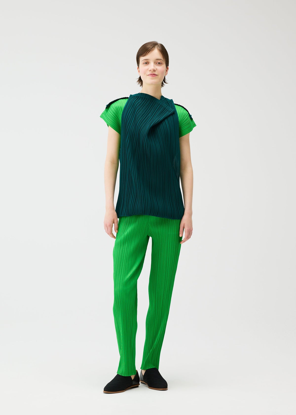 A model wears the Pleats Please Issey Miyake SWING dress.